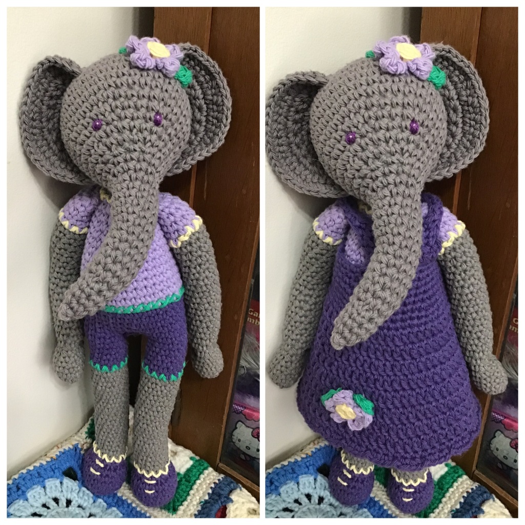 Elephant doll in dark grey with purple t-shirt and shorts and in a purple dress