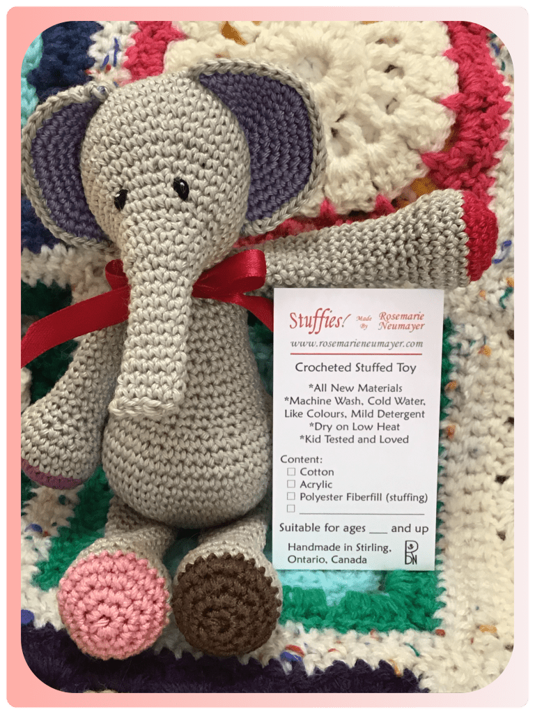 Picture of elephant stuffie displaying a care tag for my handmade stuffies