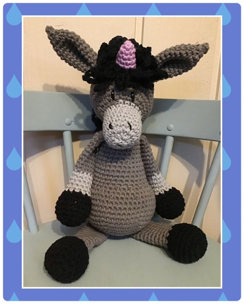 Unicorn donkey in greys with purple horn