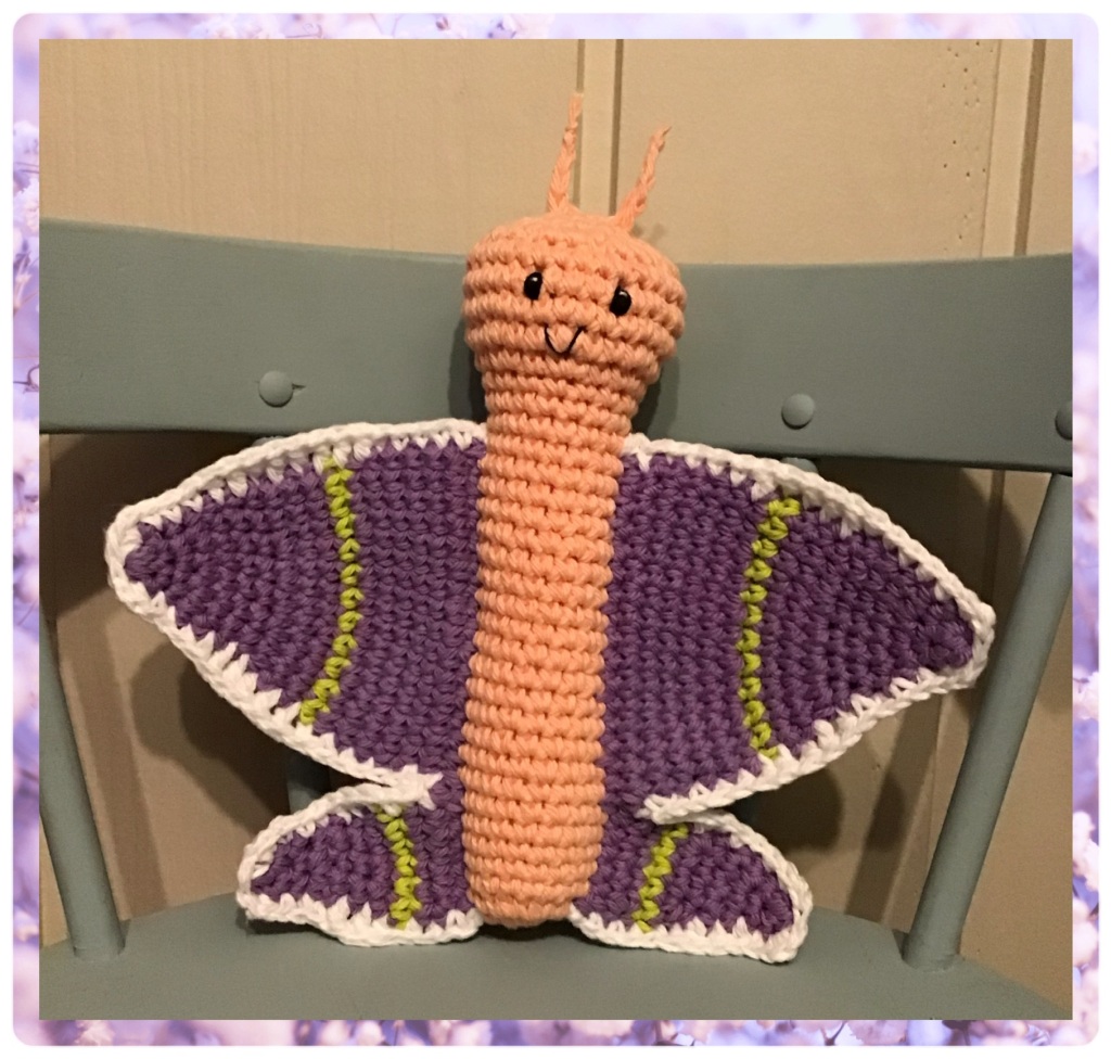 Butterfly stuffed animal standing on a chair