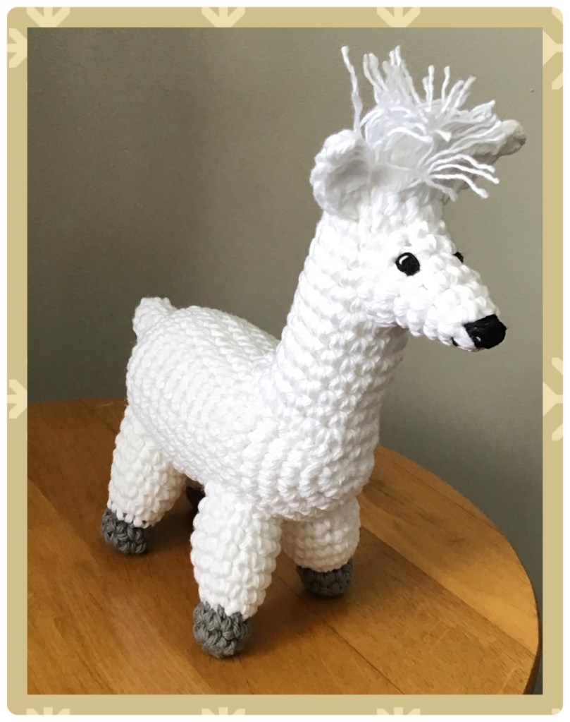 Alpaca stuffie standing on a table