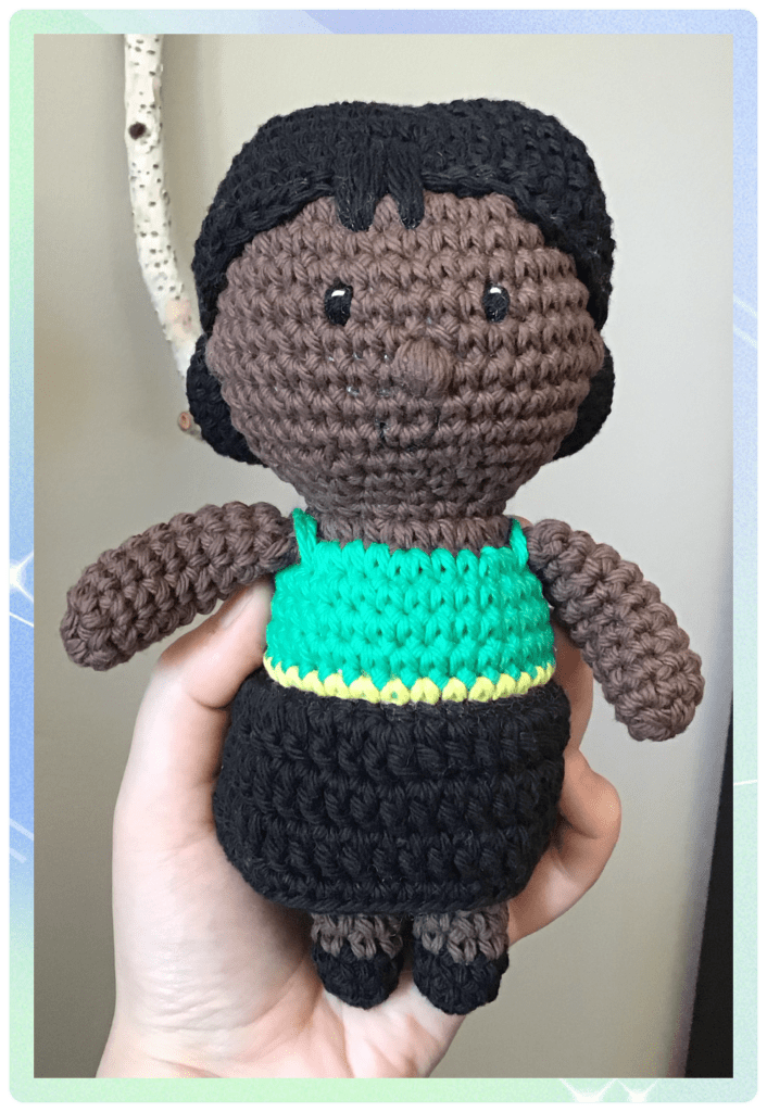 Girl stuffie doll. My own oattern. This one is wearing a dress inspired by the Jamaican flag. Dark complexion, hair and eyes