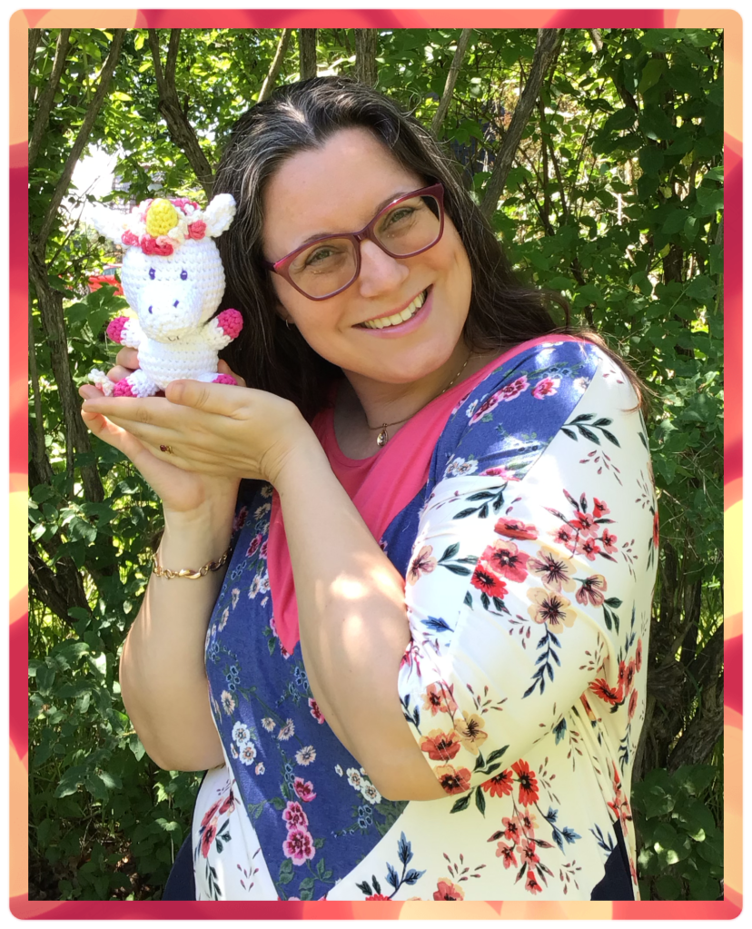 A picture of Rosemarie holding a unicorn stuffie taken outside in summer taken by Jeff Lubetsky