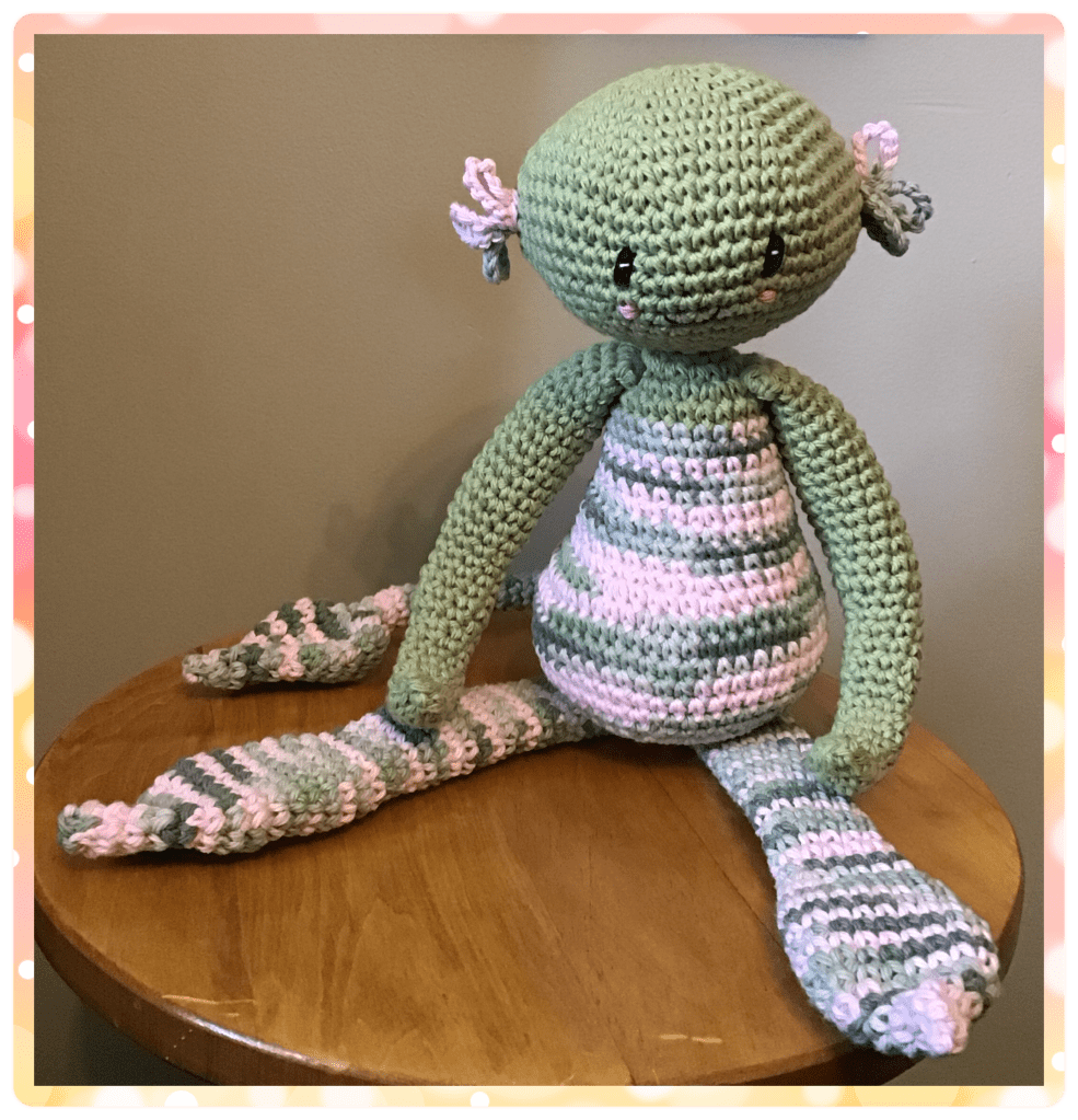 A nyad monster in green and pinks 