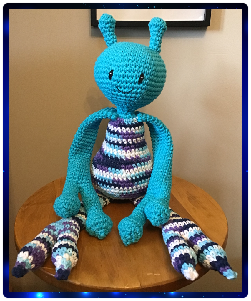 A blueish alien with long finger and legs. Two stocks on on the top of it's head.