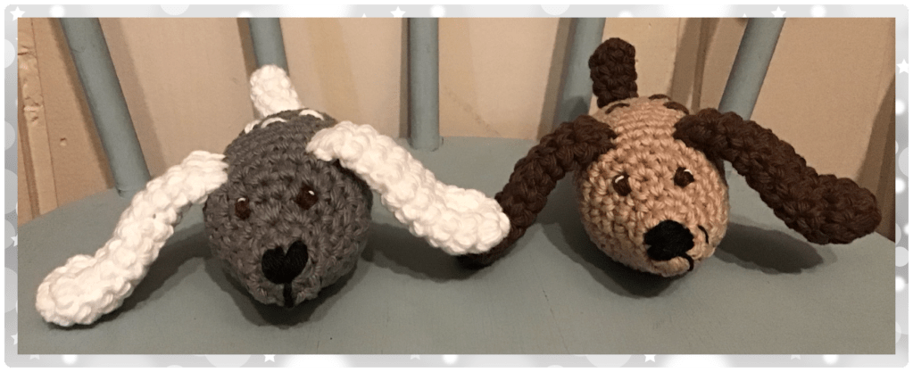 Two "bun dogs". They have long floppy ears and chubby round bodies. One is grey and white the other is tan and brown.